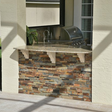 Poolside outdoor kitchen and gas fireplace