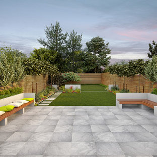 Photo of a large contemporary back patio in Hampshire with a water feature, tiled flooring and no cover.