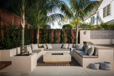 Design ideas for a large modern back patio in Orange County with a fire feature, concrete slabs and no cover.