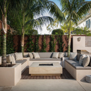 Idee per un grande patio o portico moderno dietro casa con un focolare, lastre di cemento e nessuna copertura