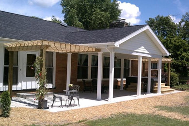Inspiration for a mid-sized timeless backyard concrete patio remodel in Cleveland with a roof extension