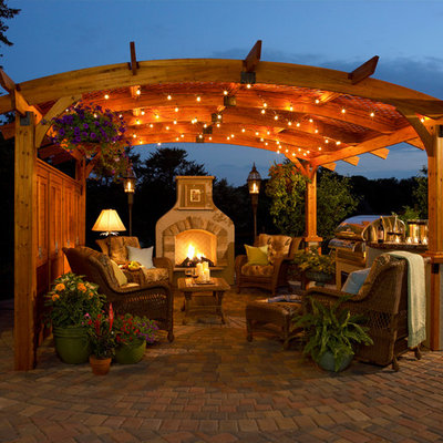 Example of a classic concrete paver patio design in Milwaukee with a gazebo