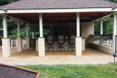 Patio kitchen - large transitional backyard stamped concrete patio kitchen idea in New York with a pergola