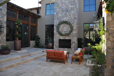 Example of a tuscan patio design in Miami with a fire pit