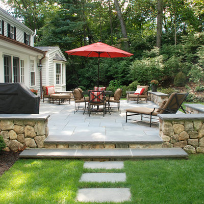 Example of a large classic backyard concrete paver patio design in Miami with no cover