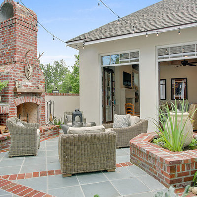 Mid-sized transitional courtyard brick patio photo in New Orleans with no cover