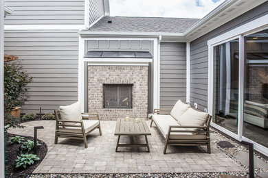 Example of a courtyard patio design in Indianapolis with a fire pit
