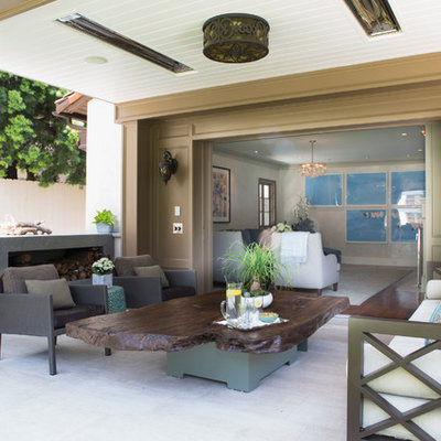 Inspiration for a transitional patio remodel in Los Angeles with a roof extension and a fireplace