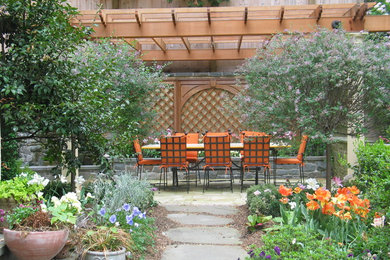 Inspiration for a mediterranean patio fountain remodel in DC Metro with a pergola