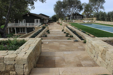 Patio fountain - huge mediterranean backyard stone patio fountain idea in Los Angeles with no cover