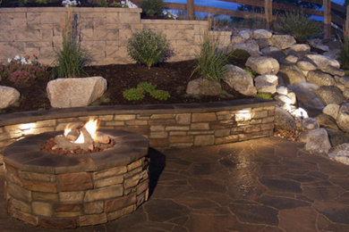 Patio - backyard patio idea in Grand Rapids with a fire pit and no cover
