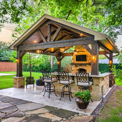 Example of a mid-sized mountain style backyard tile patio design in Houston with a gazebo
