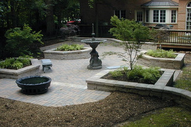 Large backyard brick patio fountain photo in Baltimore with no cover