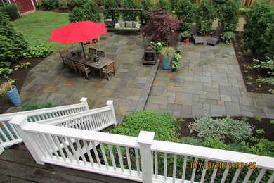 Large elegant backyard stone patio photo in Bridgeport with no cover