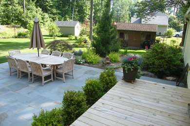 Patio - large traditional backyard stone patio idea in Bridgeport with no cover