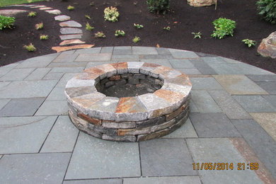 Patio - large traditional backyard concrete patio idea in Bridgeport with a fire pit and no cover