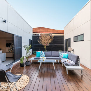 This is an example of a modern courtyard patio in Other with decking and no cover.