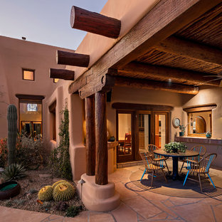 Southwest backyard patio photo in Phoenix with a roof extension