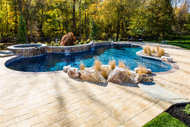 Example of a huge classic backyard pool design in New York
