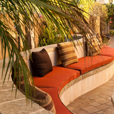 Tuscan concrete paver patio photo in San Diego with no cover