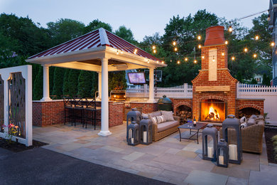 Example of a large classic backyard tile patio kitchen design in Philadelphia with a gazebo