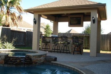 Large trendy backyard stone patio kitchen photo in Phoenix with a gazebo