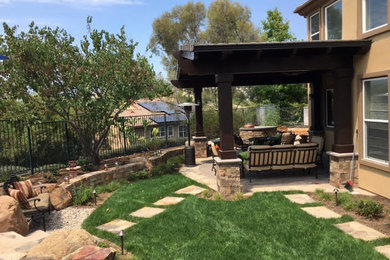 Patio - mediterranean backyard patio idea in Orange County with a pergola