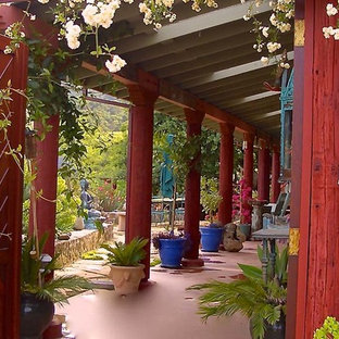 Mid-sized asian backyard concrete patio fountain photo in Phoenix with a roof extension