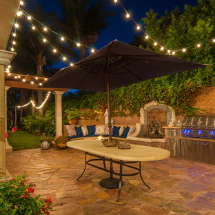 Patio kitchen - mediterranean stone patio kitchen idea in Los Angeles with no cover