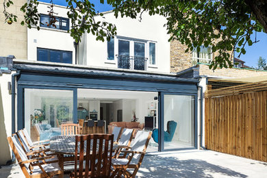 This is an example of a large contemporary patio in London with no cover.