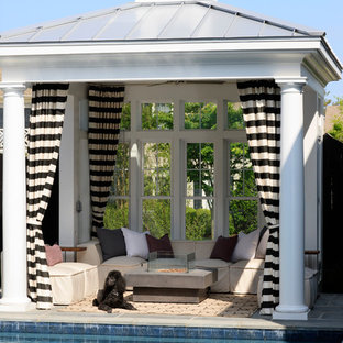 Beach style backyard tile patio photo in DC Metro with a gazebo and a fire pit