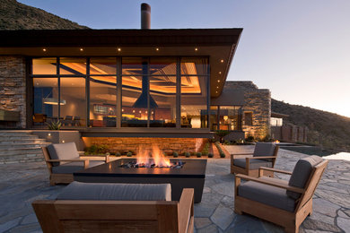 Example of a trendy patio design in Phoenix with a fire pit