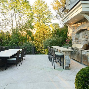 Huge elegant backyard decomposed granite patio kitchen photo in New York with no cover