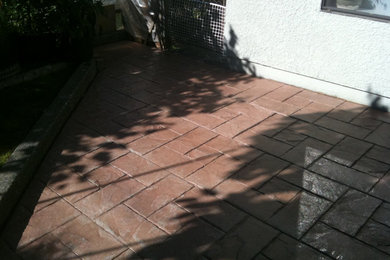 Patio - mid-sized backyard concrete paver patio idea in Vancouver with no cover