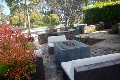 Modelo de patio clásico renovado de tamaño medio sin cubierta en patio trasero con adoquines de piedra natural