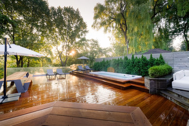Inspiration for a large transitional backyard patio remodel in Toronto with decking and no cover