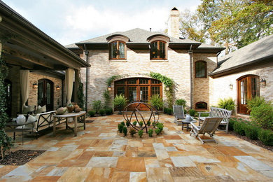 Mid-sized elegant courtyard stone patio photo in Atlanta with no cover