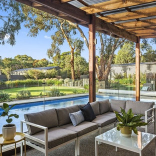 Photo of a contemporary patio in Geelong with concrete slab and a pergola.