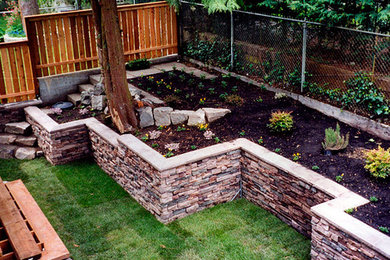Example of a backyard stone patio container garden design in Portland with no cover