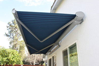 Inspiration for a large modern back patio in San Francisco with an awning.