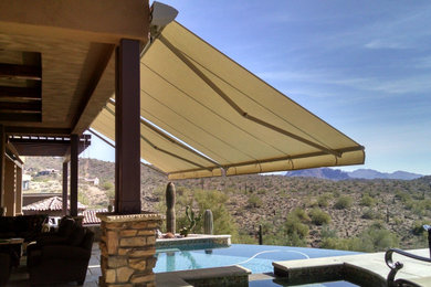 Large trendy backyard tile patio photo in Phoenix with an awning