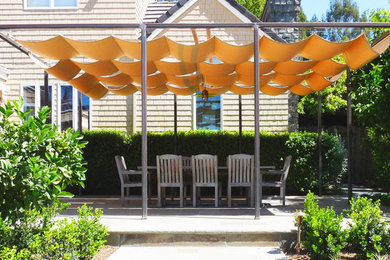 Example of a classic patio design in San Francisco with a pergola