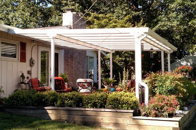 Example of a classic backyard patio design in Philadelphia with a pergola