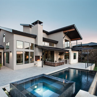 Example of a mid-sized trendy backyard concrete patio kitchen design in Austin with a roof extension