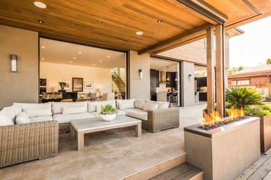 Photo of a medium sized contemporary back patio in San Francisco with tiled flooring and a roof extension.