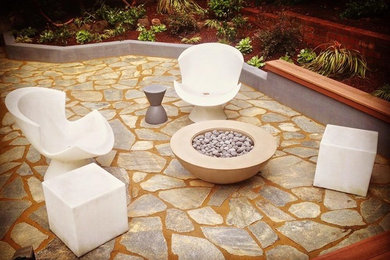 Design ideas for a medium sized contemporary back patio in San Francisco with a fire feature, natural stone paving and no cover.