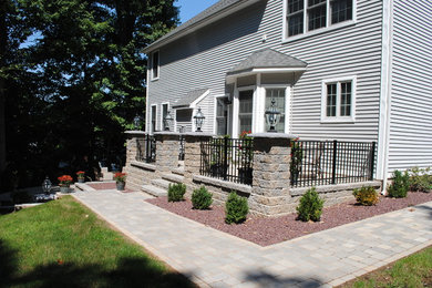 Example of a classic backyard concrete paver patio design in Bridgeport with no cover