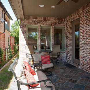 Example of a large transitional side yard brick patio design in Dallas with a roof extension