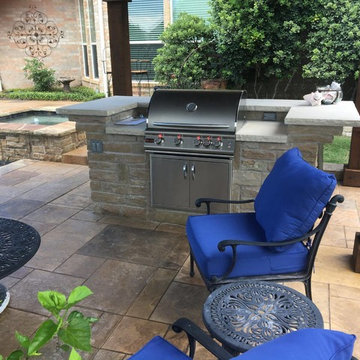 Rowlett - Patio cover with fire feature, stamped concrete and outdoor kitchen.