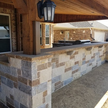 Royse city -  Stone outdoor kitchen, Cedar patio cover with gable.